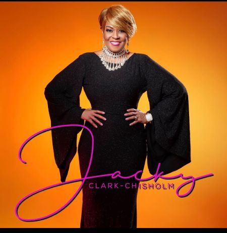 Jacky Clark-Chisholm  poses for a photoshoot in a lovely black gown.